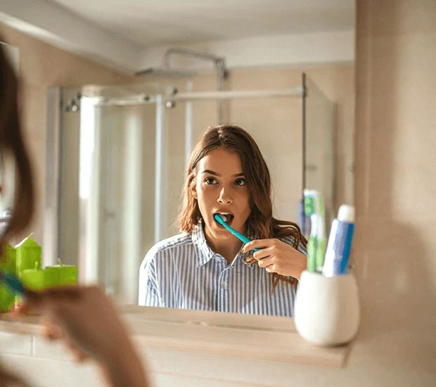 lady brushing her teeth